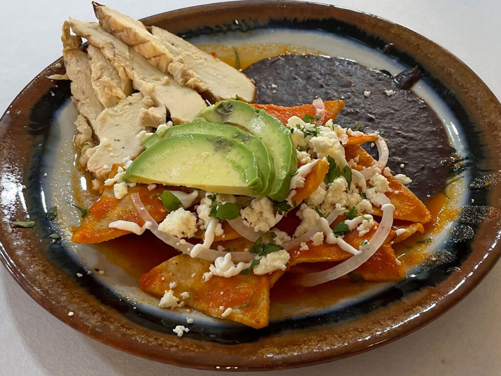 Chilaquiles with slices of roast pork at zandoyo bed & breakfast