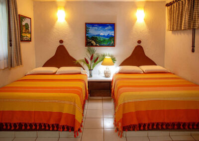 Two queen beds in the room Ines at Zandoyo Bed & Breakfast