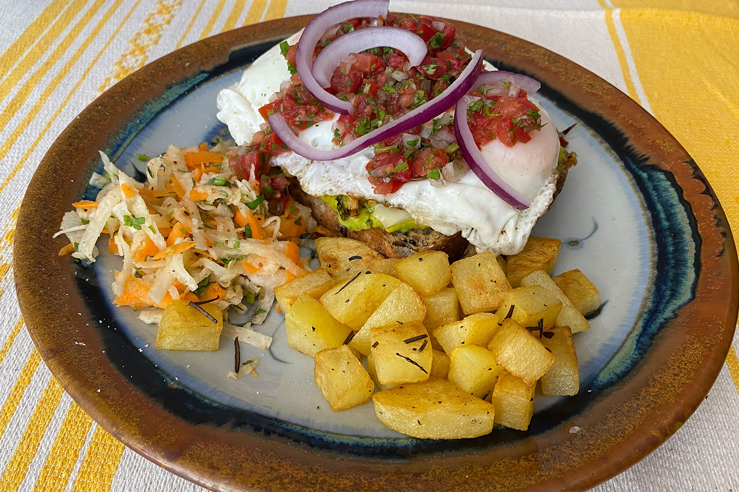 A mollete served with rosemary potatoes and a salad.
